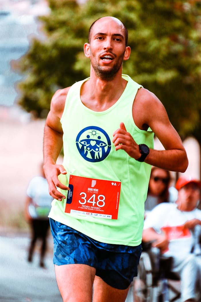 Focused athlete running a vibrant outdoor marathon in bright attire.